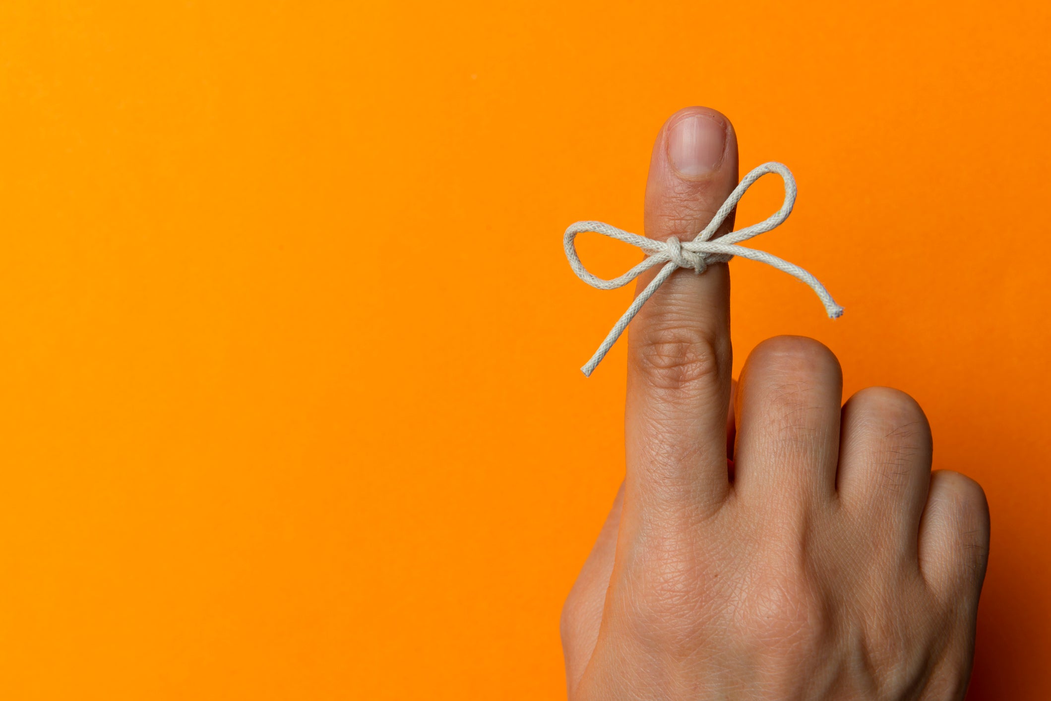 An index finger wrapped in string on for memory