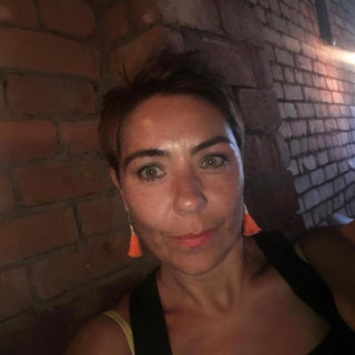 woman with short hair looking at the camera.